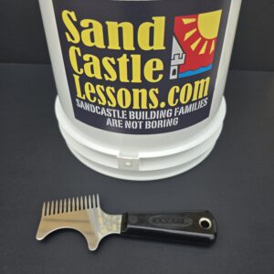 Image shows the Professional Wood Grain Column tool in front of a 2 gallon bucket which is used during luxury family sandcastle building lessons by sandcastle builder Andy Hancock on South Padre Island