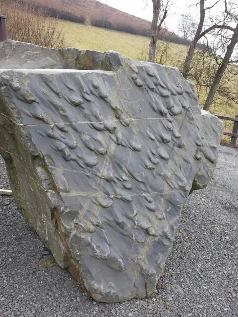 A unique geological formation found within a rock face in Wales. This picture shows what looks like molten droplets of lava that have formed inside the rock - what you would only see at a quarry before the rock or sand was processed.