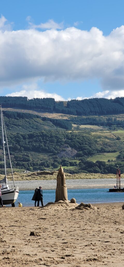 A large, six feet tall sandcastle standing on the estuary beach of Barmouth in mid-Wales proving that Andy Hancock's science of sandcastle building method can work all over the world.